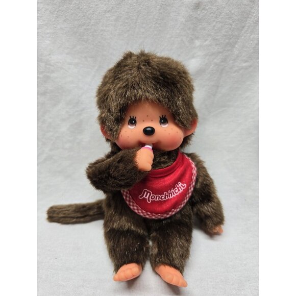 SEKIGUCHI 7.5" MONCHHICHI BOY WEARING RED BIB HOLDING PACIFIER DOLL - Picture 1 of 10